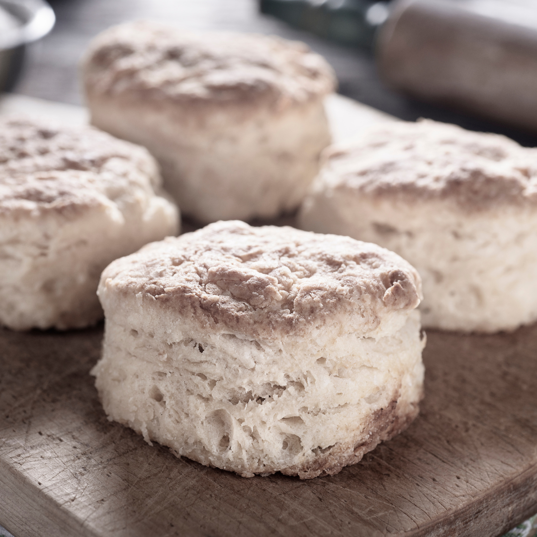 fresh biscuits sit on a serving board