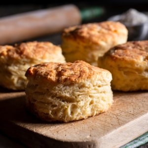 fresh buttermilk biscuits sit on a serving board