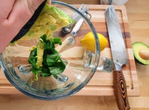 Ingredients being combined into a blender for processing.