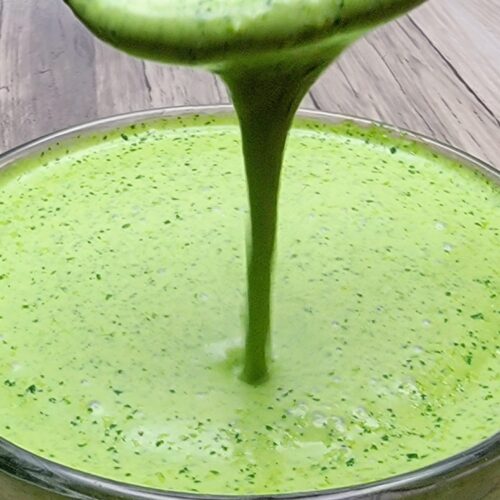 Creamy Cilantro Lime Dressing dripping form a spoon.