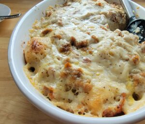 white casserole dish with biscuits and gravy breakfast casserole.